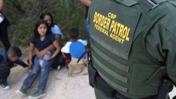 Central American asylum seekers wait as U.S. Border Patrol agents take them into custody on June 12, 2018. Photo by John Moore/Getty Images